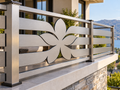 Custom brushed metal balcony railing panel with flower cutout design