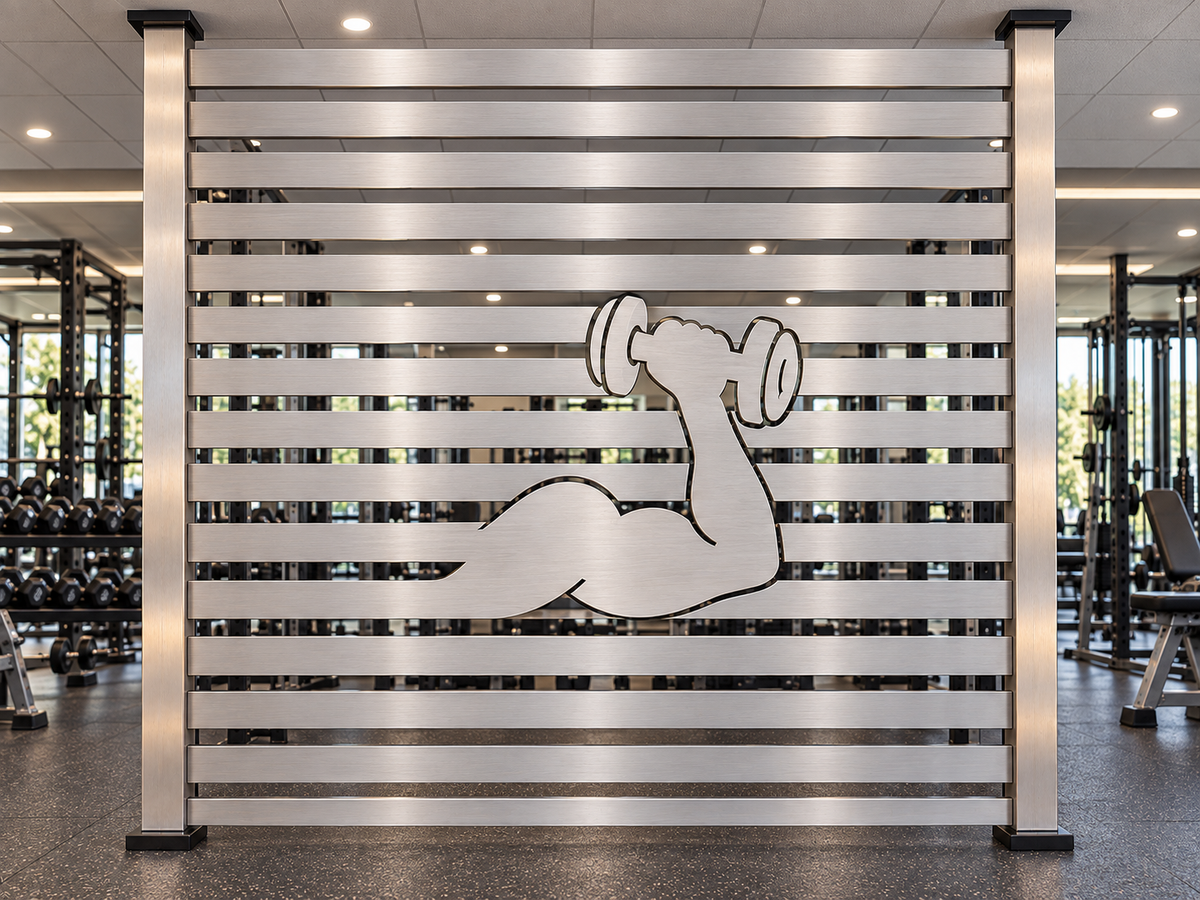 Custom brushed metal gym divider panel with flexing arm and dumbbell cutout