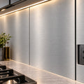 Custom sized ACP panels as a brushed metal kitchen backsplash